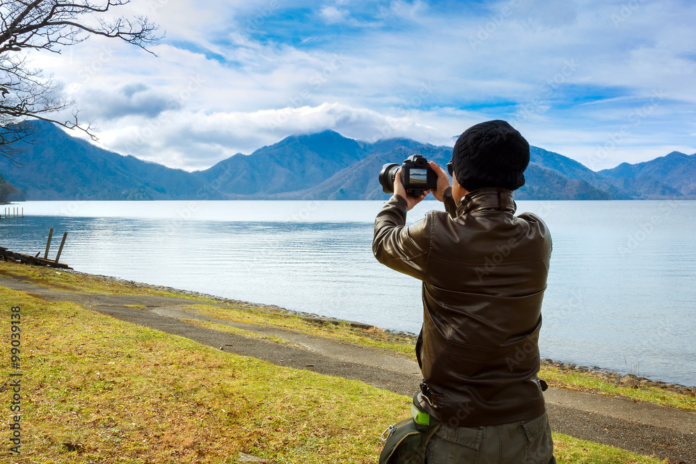 An Asian Man is Taking Photo by the Lake
