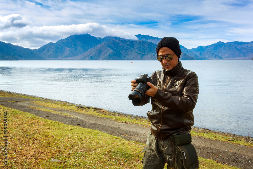 An Asian Man is Taking Photo by the Lake