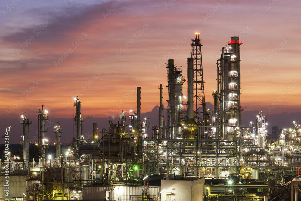 Oil refinery plant at sunset, The night view of petroleum and petrochemical factory with distillation column, drum and pipeline. Gas, diesel and chemical business industry is important for economy.