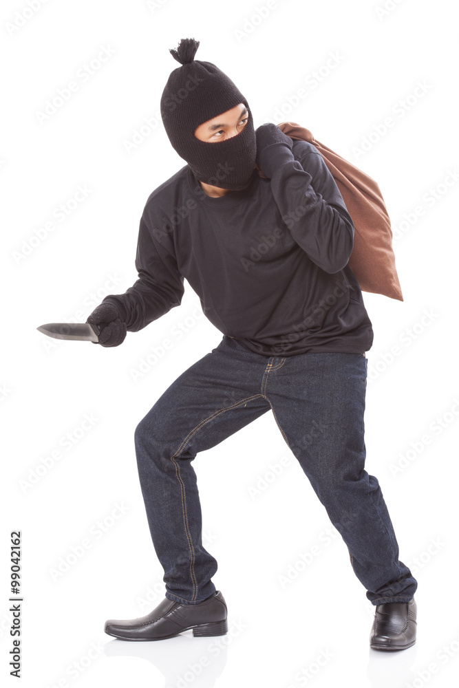 Burglar in mask holding knife on white background Burglar in mask holding knife on white background