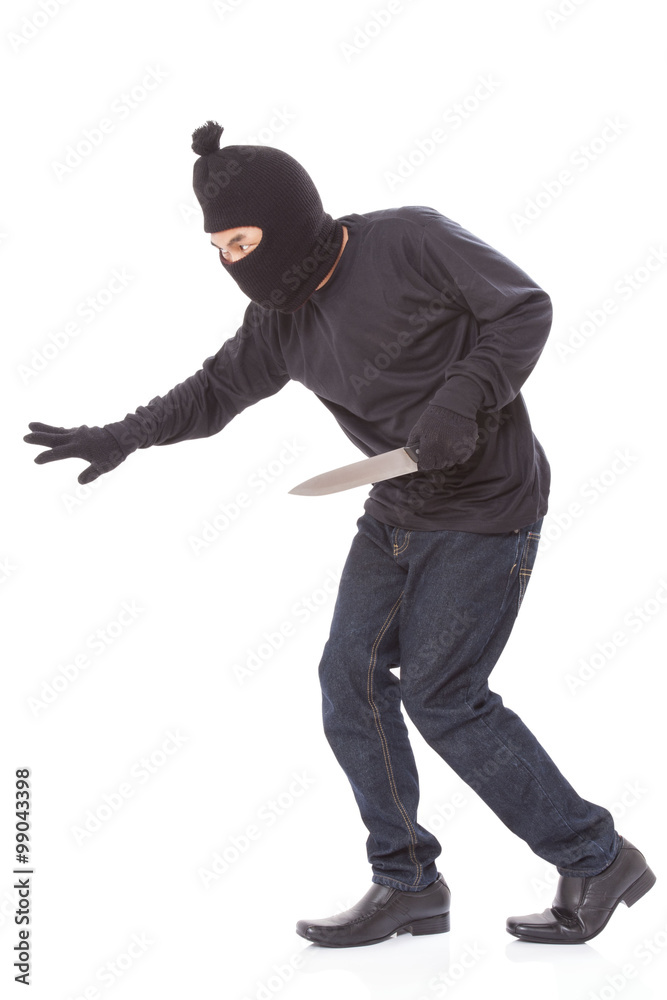 Burglar in mask holding knife on white background Burglar in mask holding knife on white background