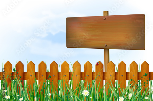 Wooden fence and sign on spring meadow