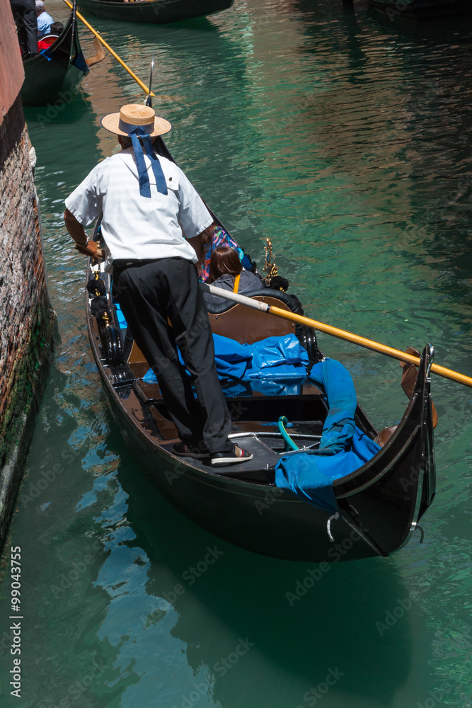 Gondolier in Typical Canal in Venice, Italy