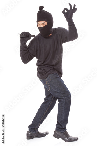Thief holding flashlight with showing ok sign on white background 