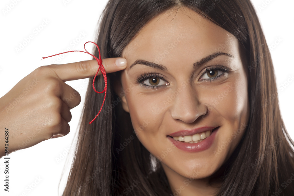 forgetful young woman with a finger tied with a red rope forgetful young woman with a finger tied with a red rope