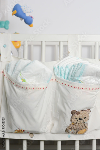 Stack of diapers in bags on a baby bed © adrian_ilie825
