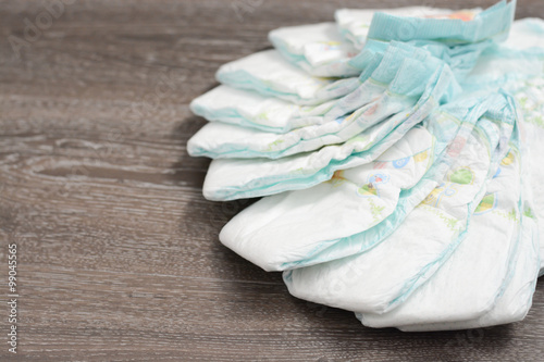 Fototapeta Naklejka Na Ścianę i Meble -  Stack of diapers in bags on a baby bed