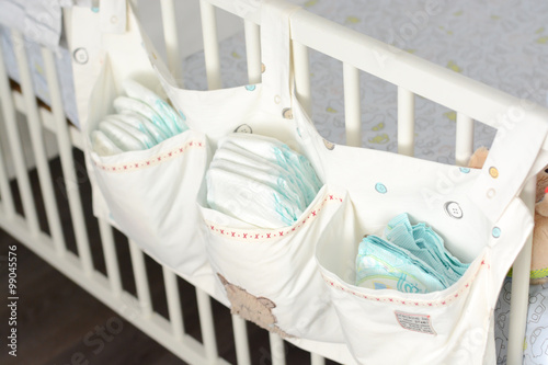 Tableau sur toile Stack of diapers in bags on a baby bed