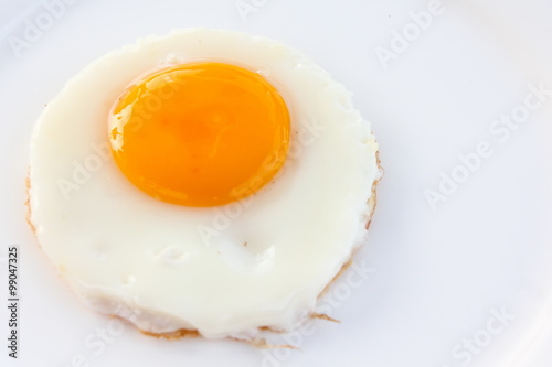 Fried egg on white plate