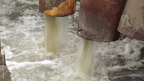 Dirty water is flowing from  Industrial pipe, discharging liquid waste