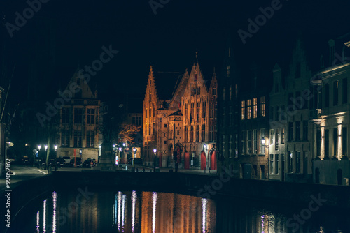 Illuminated Buildings by Canal at Night in Bruges