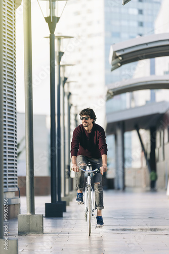 Handsome young man on bike in the city