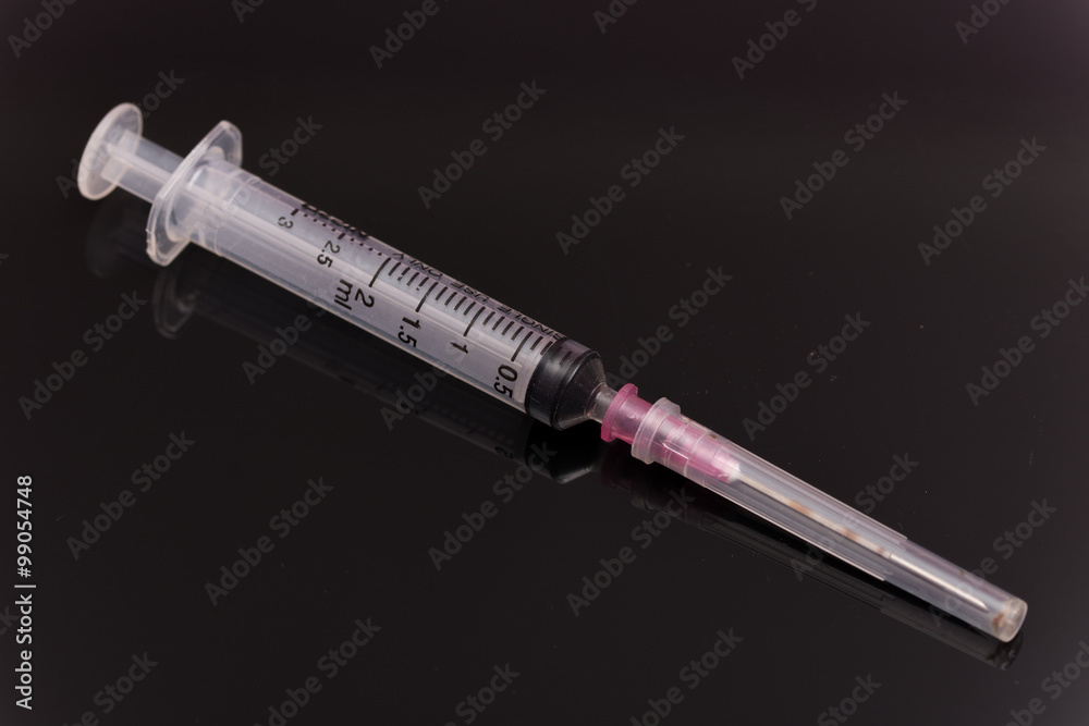 Medical syringe over black background Medical syringe over black background