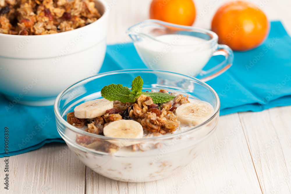 Granola with yogurt and banana in a bowl on wooden background Granola with yogurt and banana in a bowl on wooden background