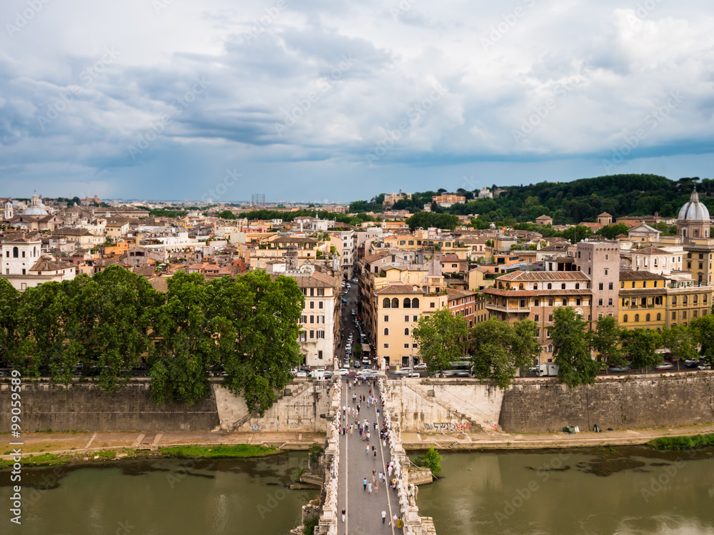 A view from above of the capital city of Rome in Italy. You also get a clear view of tourists on the Bridge of Hadrian (Ponte Sant’Angelo) - the bridge filled with angel statues.