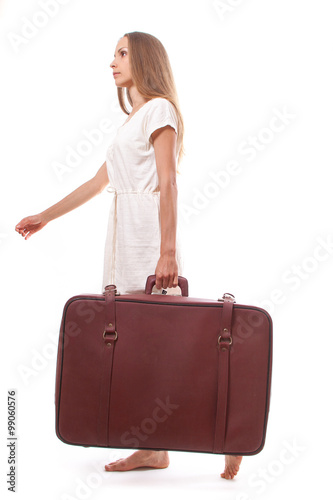 woman going with heavy suitcase, isolated on white