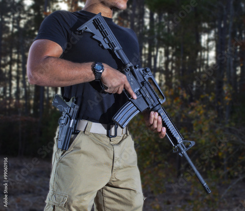 Guard duty outdoors for one militia member with an AR-15 and semi-auto pistol by his side