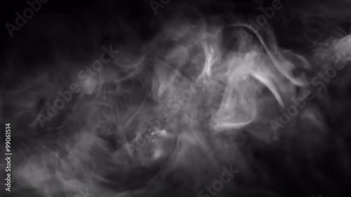 Smoky fog rises up into a beam of light.  Recorded against a black background and intended as a stand alone shot or for compositing using a blending mode.  Looping clip.