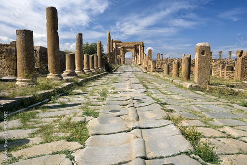 Algeria. Timgad (ancient Thamugadi or Thamugas). Paving stones of Decumanus street and Corinthian colonnade terminated Trajan's Arch