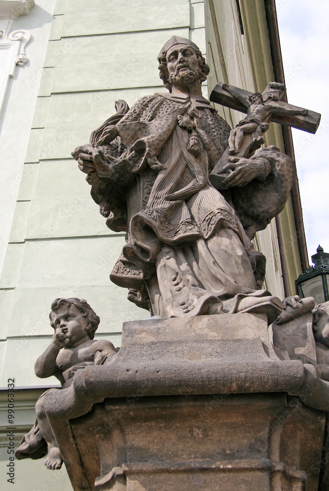 PRAGUE, CZECH REPUBLIC - APRIL16, 2010: Statue on the hotel building at stairs to the Prague Castle PRAGUE, CZECH REPUBLIC - APRIL16, 2010: Statue on the hotel building at stairs to the Prague Castle