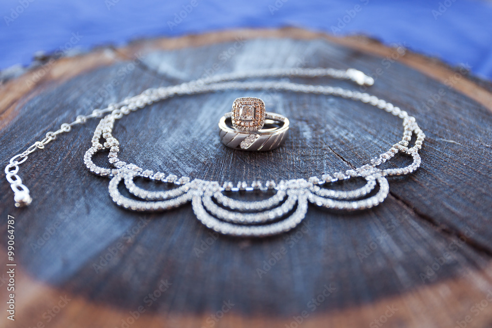 Wedding rings surrounded by the bride's necklace Wedding rings surrounded by the bride's necklace