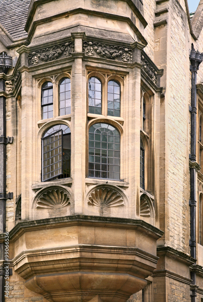 oriel window of gothic stone college building