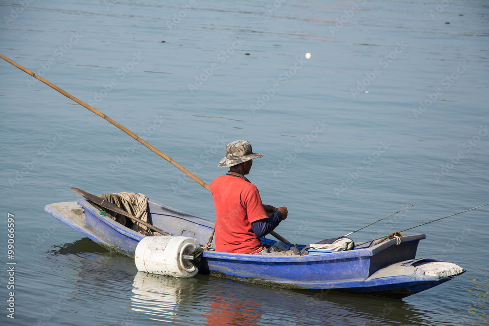 fisherman in fishing boat on water fisherman in fishing boat on water