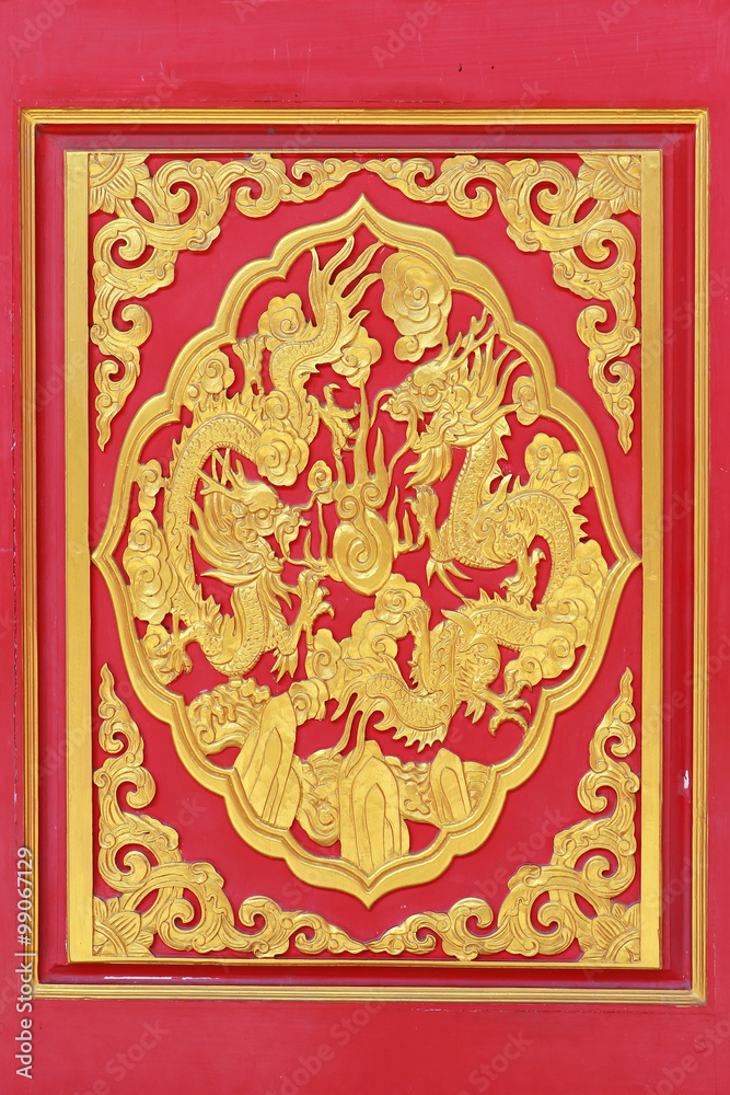 Golden dragon decorated on wood carved on red door, Chinese style in Dragon Temple Kammalawat (Wat Lengnoeiyi) in Nonthaburi, Thailand