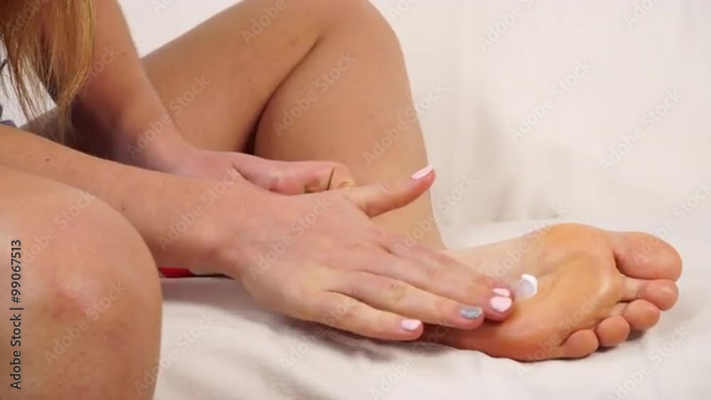 Woman taking care of her dry skin foot applying cream. 4K Woman taking care of her dry skin foot applying cream. 4K