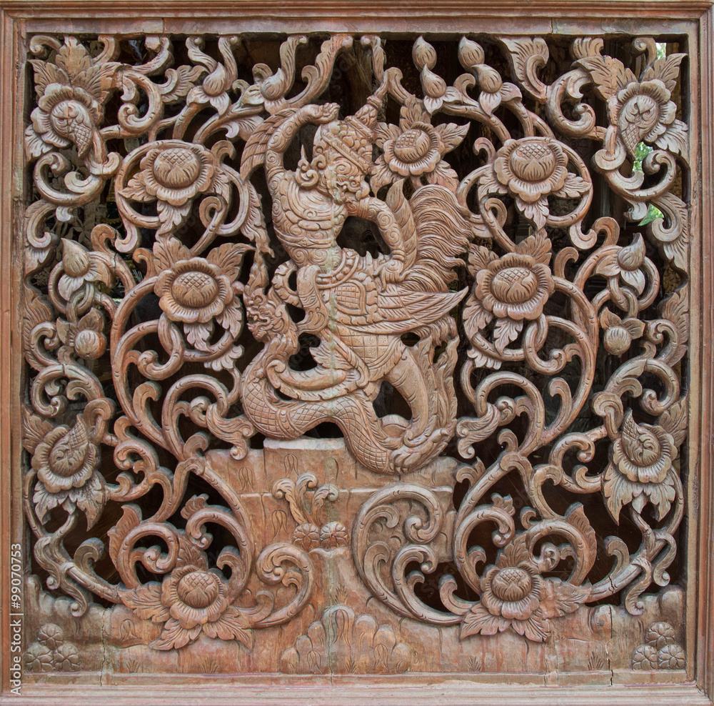 Carved wooden latticework with pattern of flowers and Garuda
