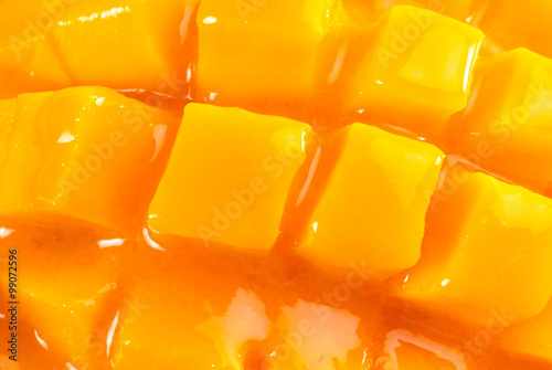 King of fruits; close-up of Alphonso yellow Mango fruit juicy cubes on mango pulp thick juice