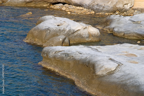 Rocks in the sea bathed in afternoon light in Akanthou, near Kyr photo