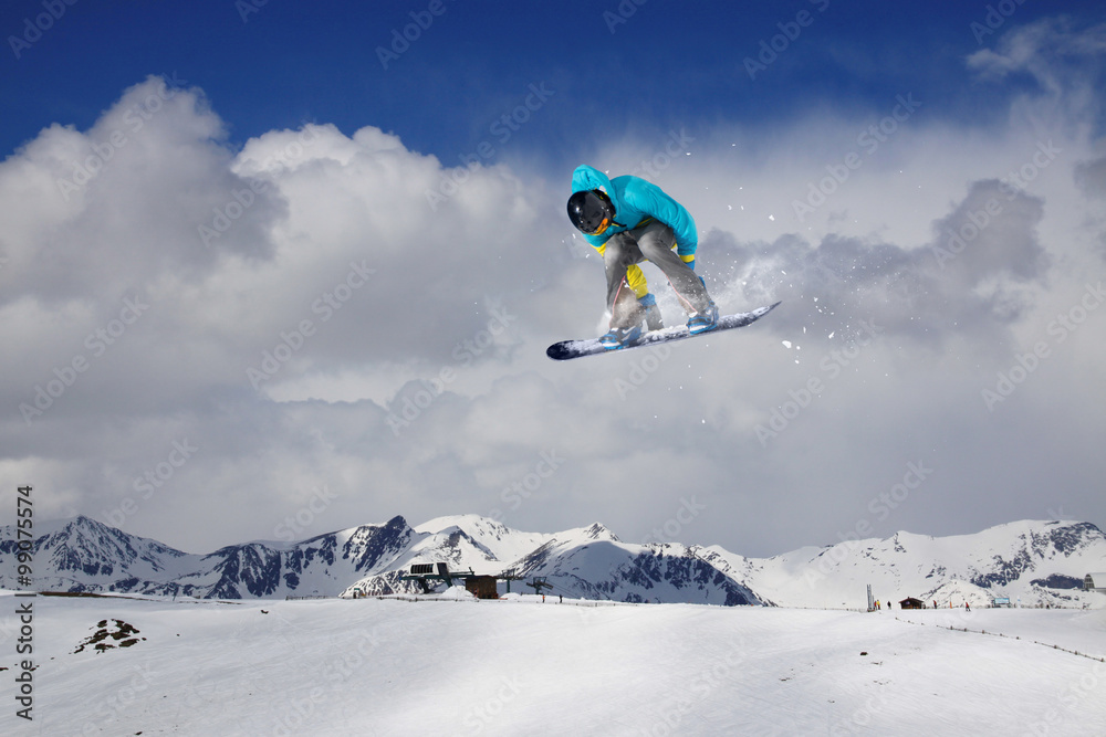 Flying snowboarder on mountains. Extreme sport.