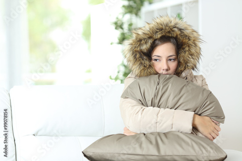 Woman warmly clothed in a cold home