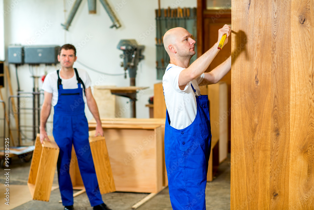two worker in a carpenter's workshop two worker in a carpenter's workshop