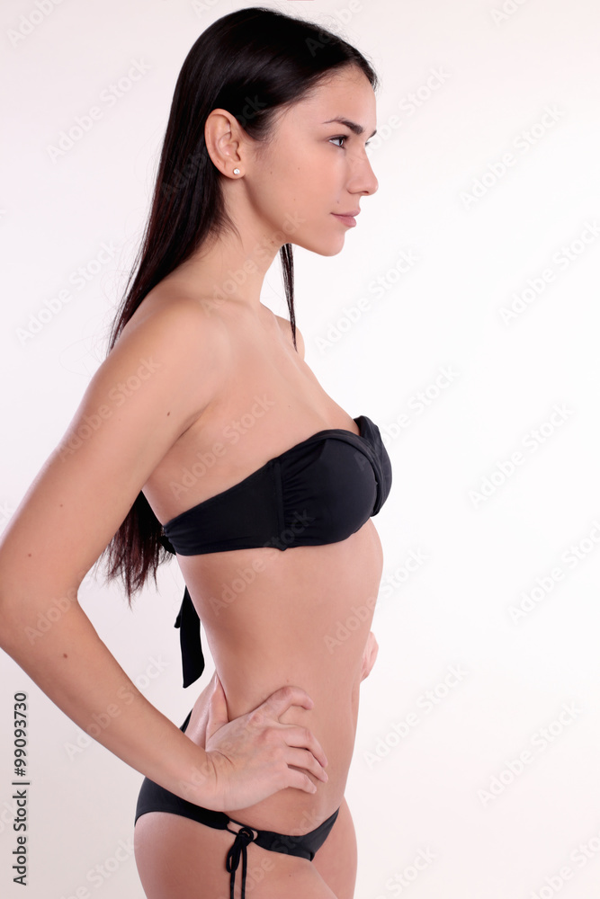 Obraz premium beautiful woman with perfect body, with dark straight hair wears black bikini