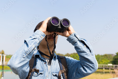 Man using binoculars for birdwatching photo