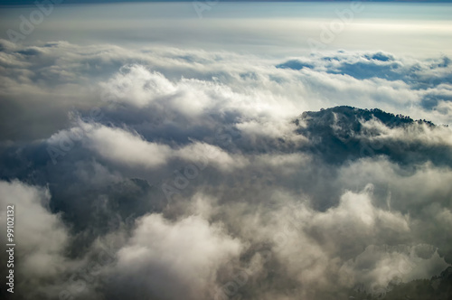 Emerging peak above clouds
