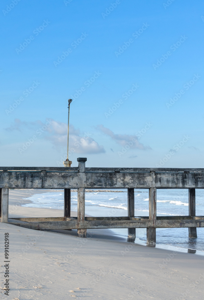 The lamp on old cement bridge behind blue sky into the sea, Thailand