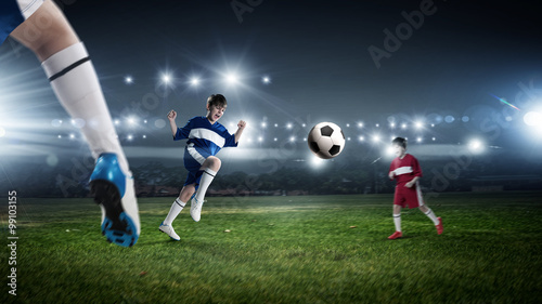 Kids play soccer on stadium  © Sergey Nivens