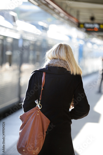 Woman waiting for incoming train