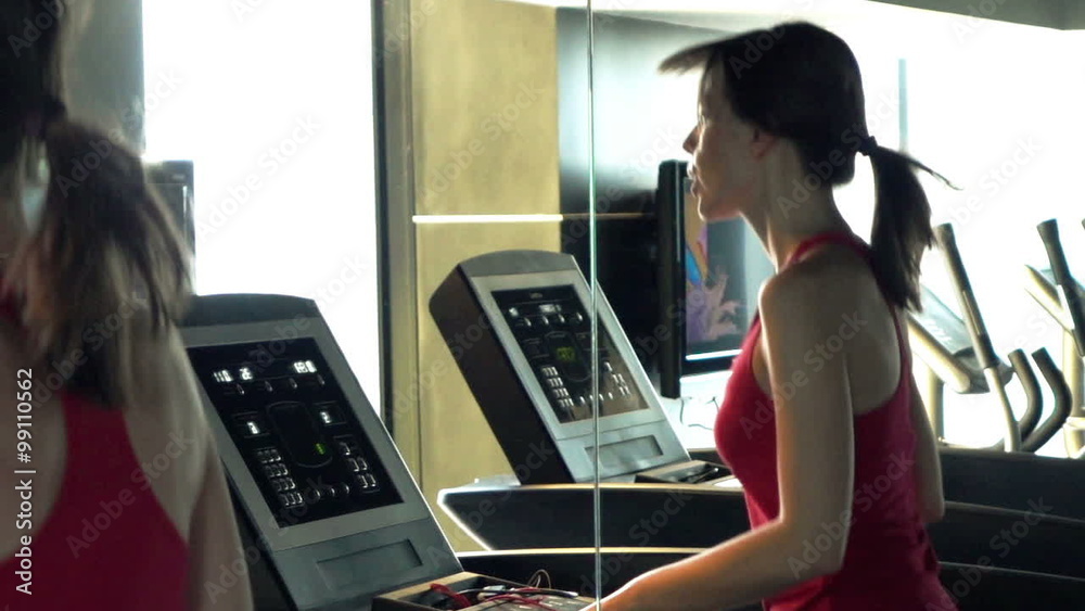 Woman running on treadmill machine in gym, super slow motion 120fps
