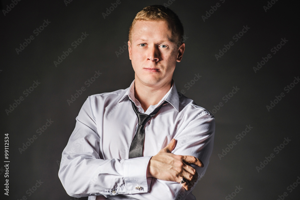Portrait of serious elegant handsome young man in classic suit toasting with ring. Undo shirt Portrait of serious elegant handsome young man in classic suit toasting with ring. Undo shirt