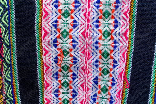 Ancient andean colored fabrics woven by hand as background