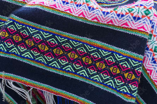 Ancient andean colored fabrics woven by hand as background