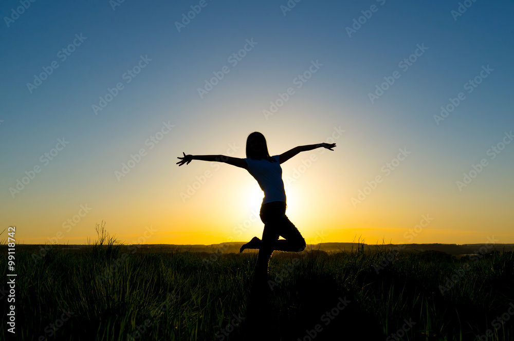 Silhouette young woman in front of a beautiful sunset Silhouette young woman in front of a beautiful sunset