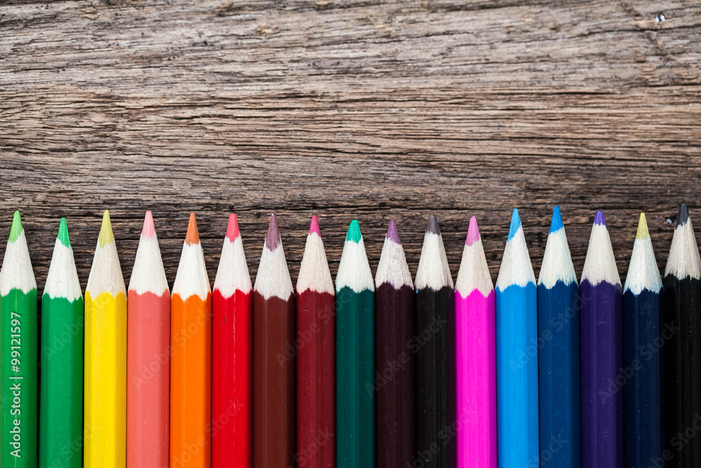 Color pencils on wooden background Color pencils on wooden background
