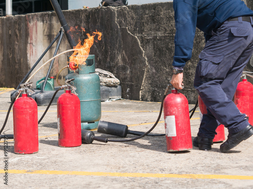 Wallpaper Mural gas tube burn while fireman holding fire extinguisher in fire dr Torontodigital.ca
