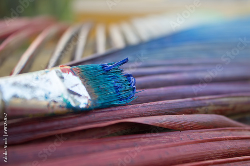 brushes after painting with rainbow background