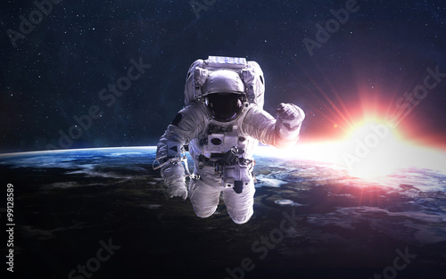 Fototapeta Naklejka Na Ścianę i Meble -  Astronaut in outer space against the backdrop of the planet earth. Elements of this image furnished by NASA.